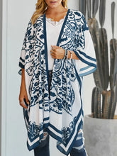 Front view of white printed open front cover-up