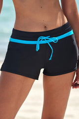 Front view of black drawstring swim shorts