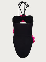 Black one-piece swimsuit with open back and tied halter