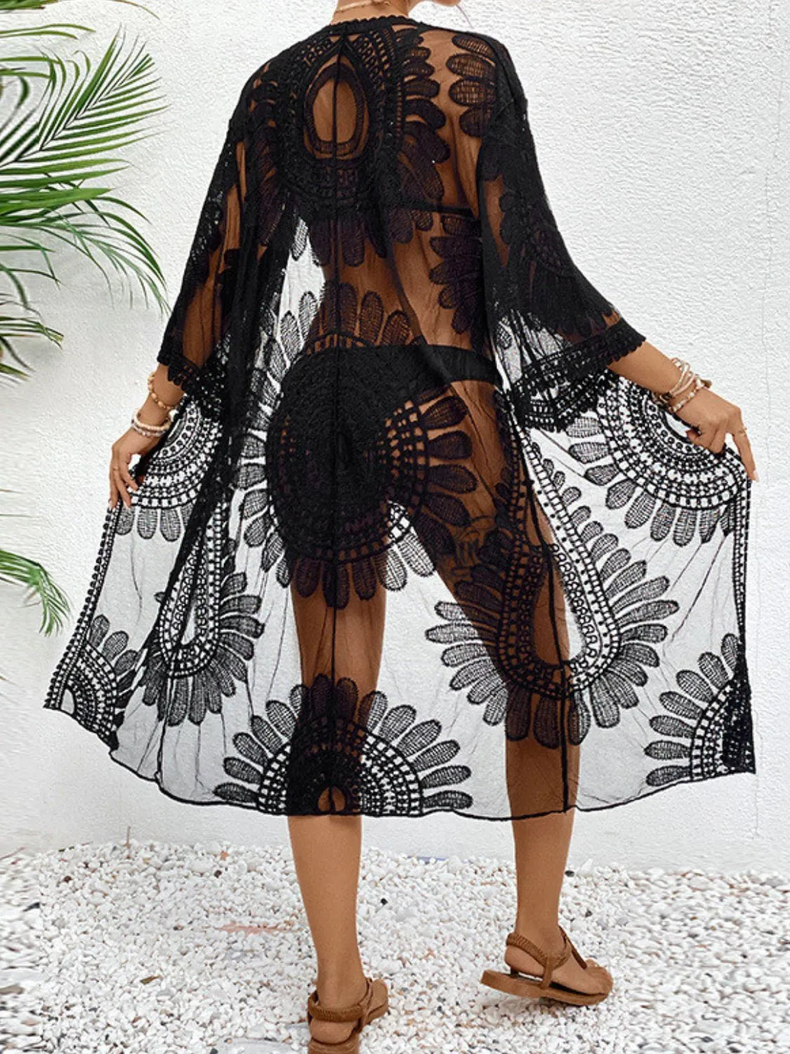 Sheer lace back of black cover-up