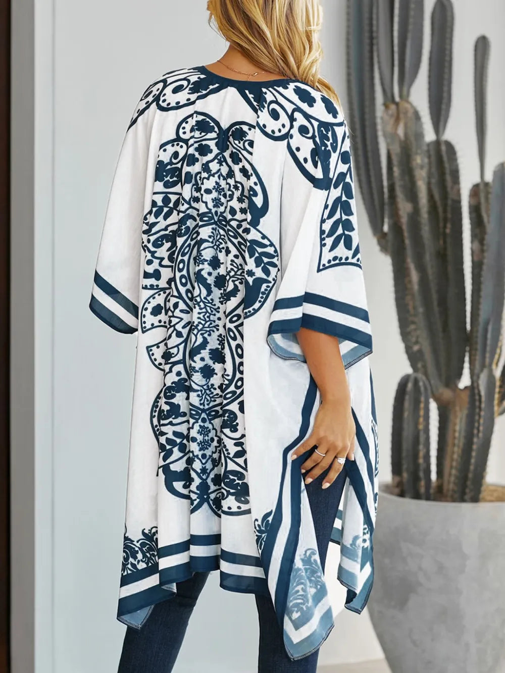 Back view of white printed open front cover-up